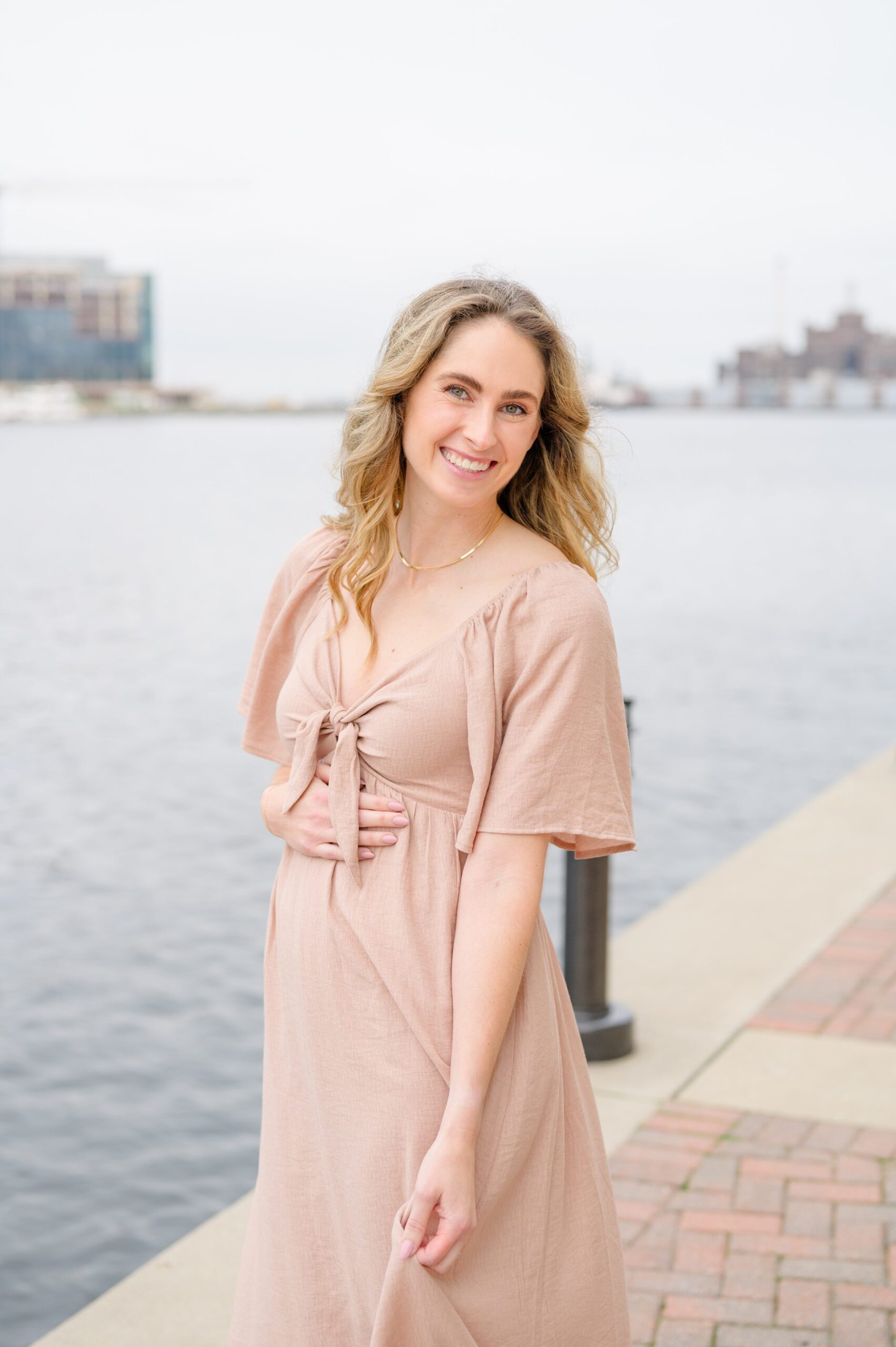 Pregnancy announcement photos at the Baltimore Inner Harbor photographed by Baltimore Maternity Photographer Cait Kramer.