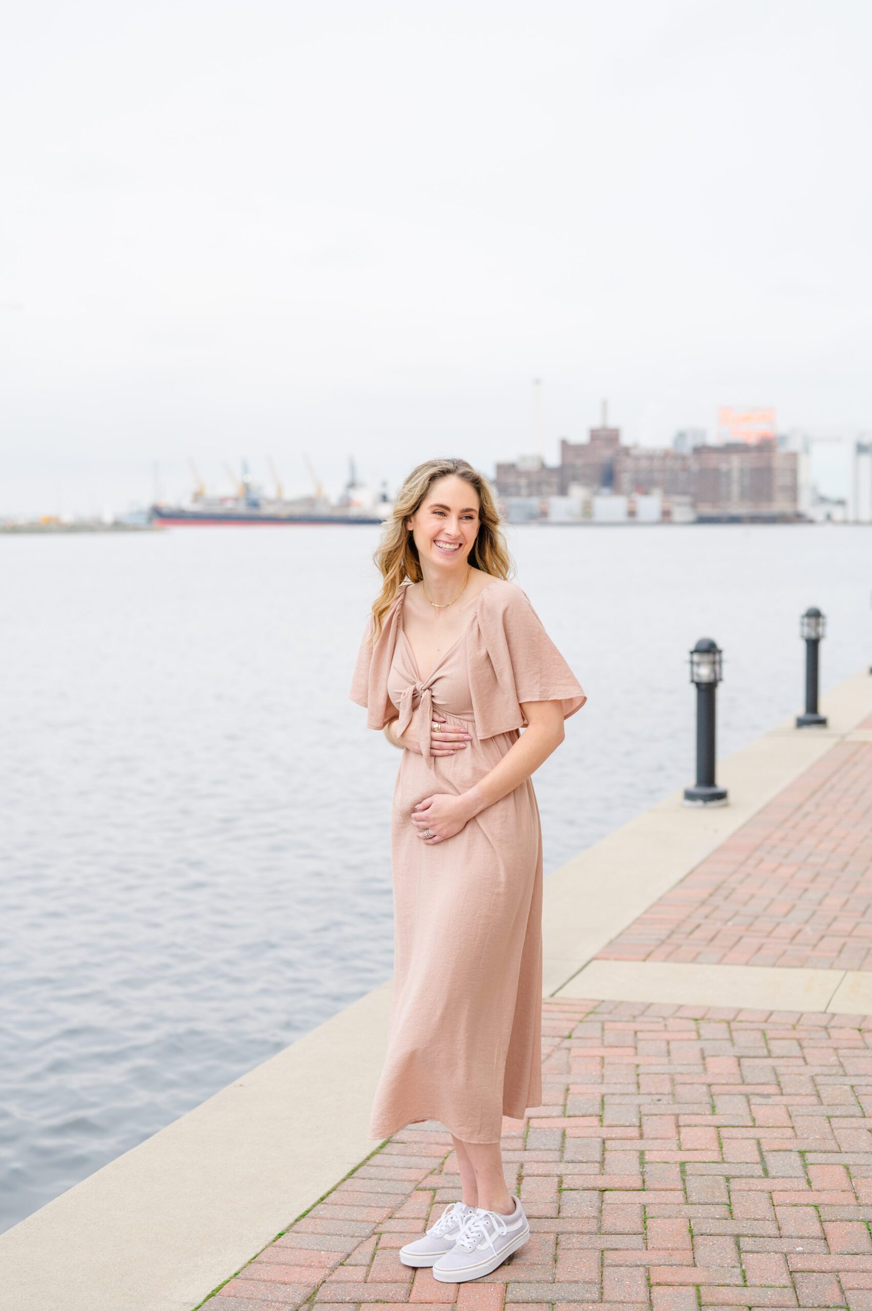 Pregnancy announcement photos at the Baltimore Inner Harbor photographed by Baltimore Maternity Photographer Cait Kramer.