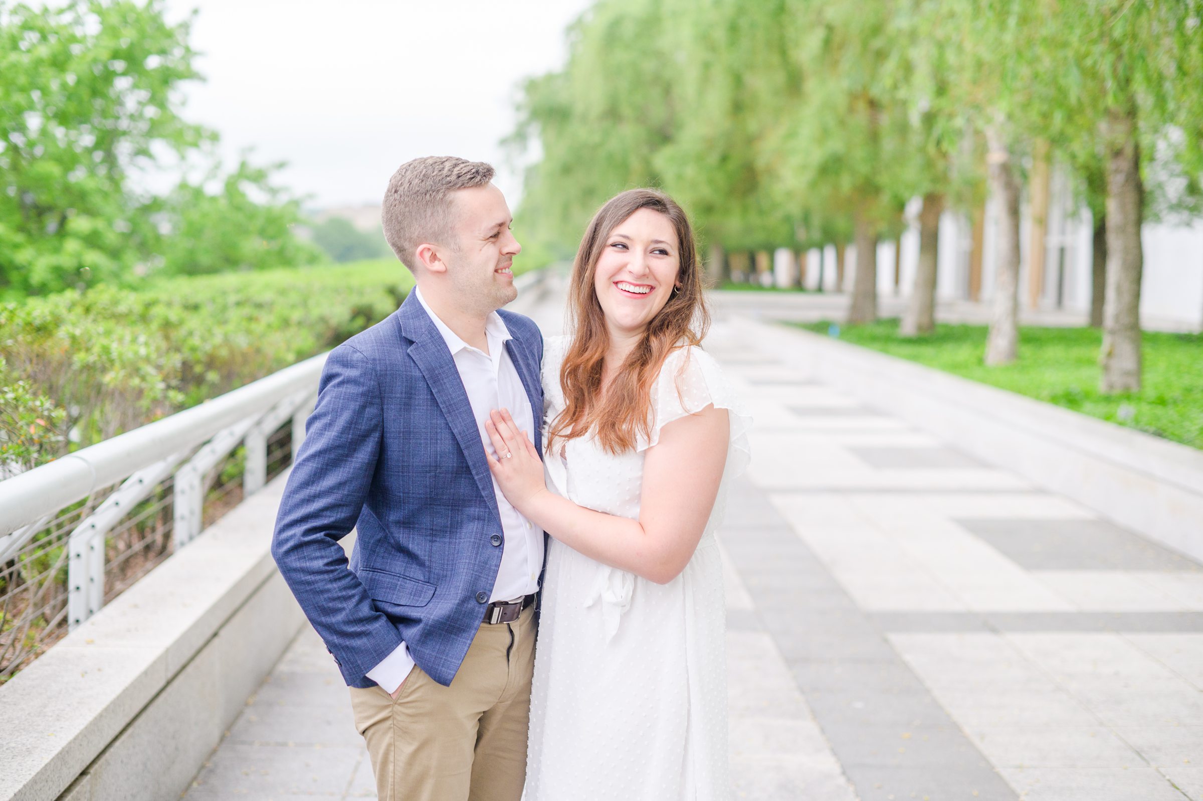 Engaged couple smiles near the Kennedy Center during engagement session at the Kennedy Center photographed by Baltimore Wedding Photographer Cait Kramer Photography