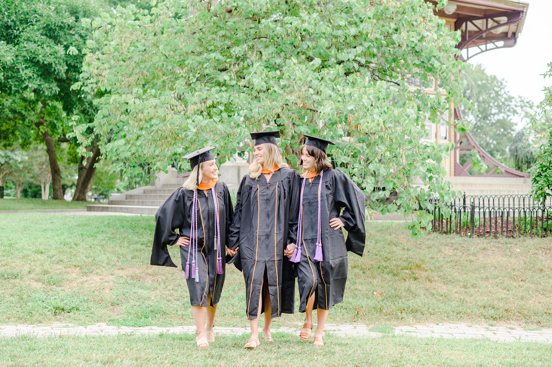 Grads walk in Patterson park during Baltimore Maryland Graduation Session