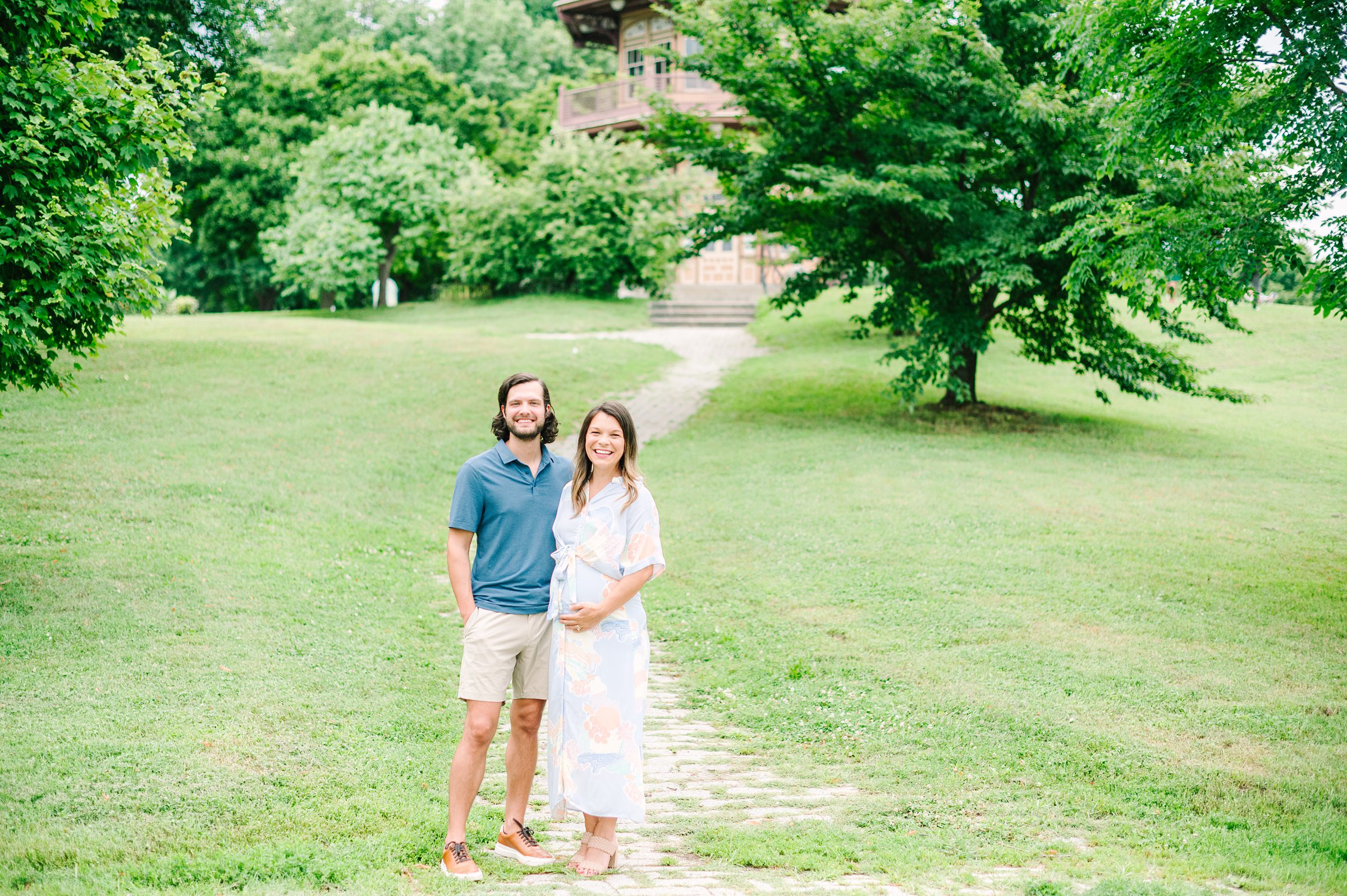 Expecting couple smiles during Patterson Park maternity session photographed by Baltimore Photographer Cait Kramer.