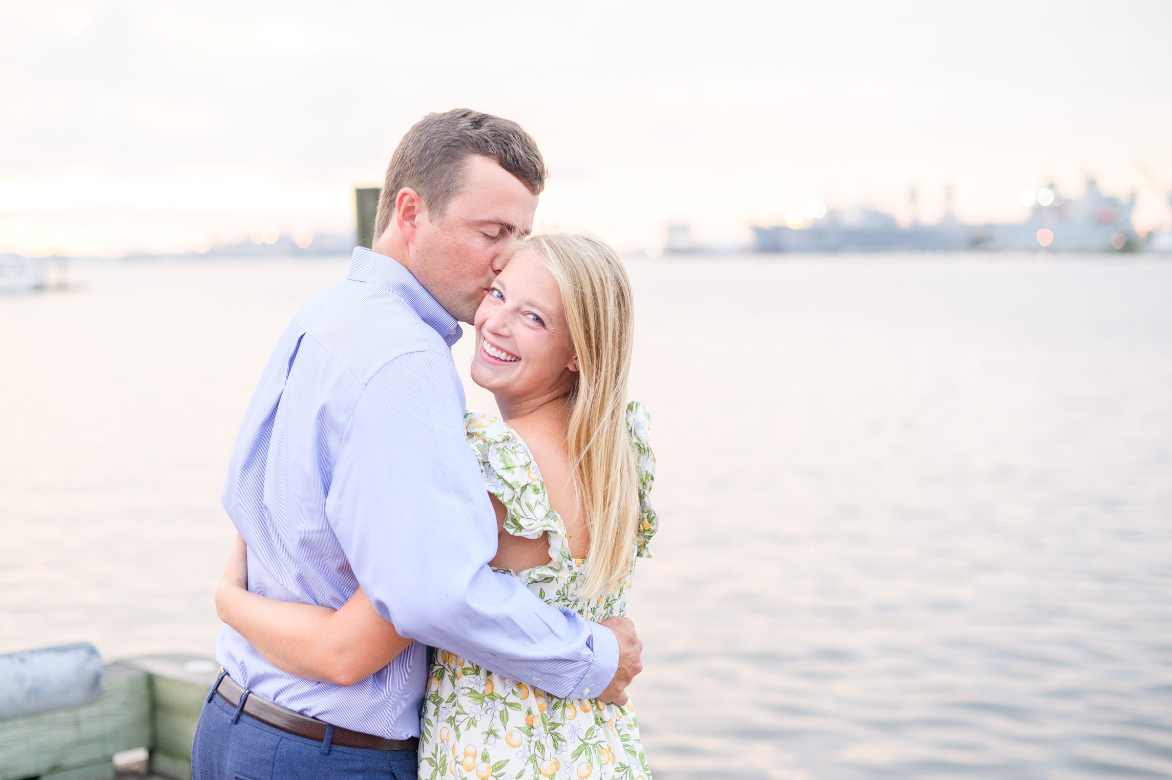 Couple poses on Broadway pier during Fells Point engagement session photographed by Baltimore wedding photographer Cait Kramer